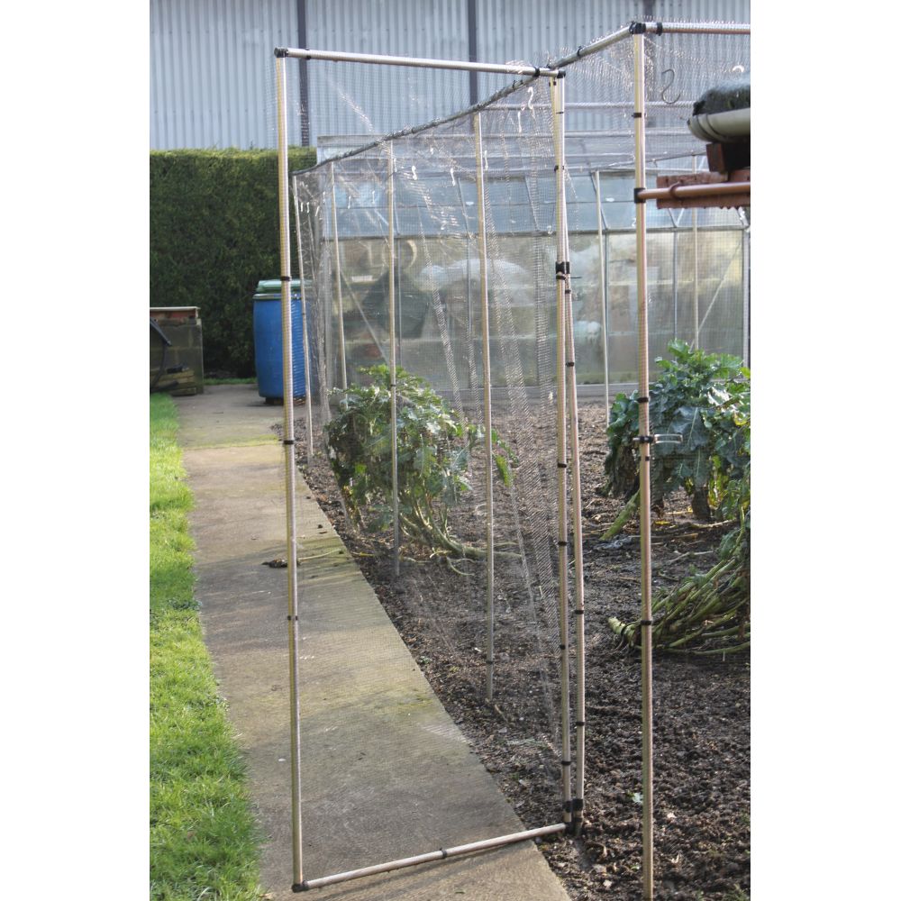 Metal garden arch with netting in a garden setting